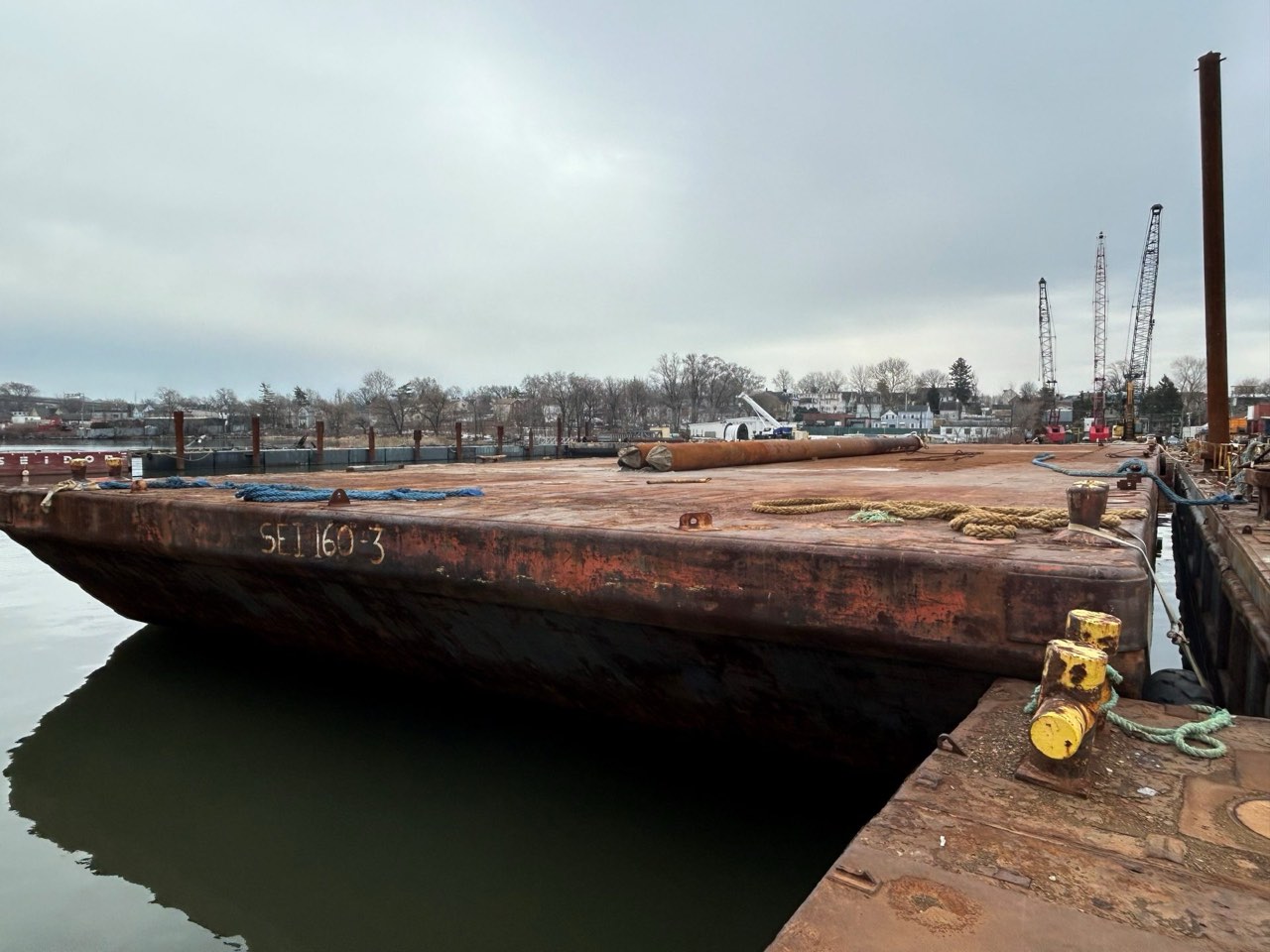 Inland spud barge alongside the yard